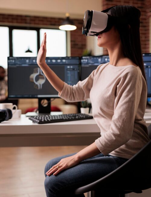 Asian technician with vr glasses developing product Asian technician with vr glasses developing product, helping with industrial machinery production. Cad engineer manufacturing gears model with virtual reality 3d headset and software.